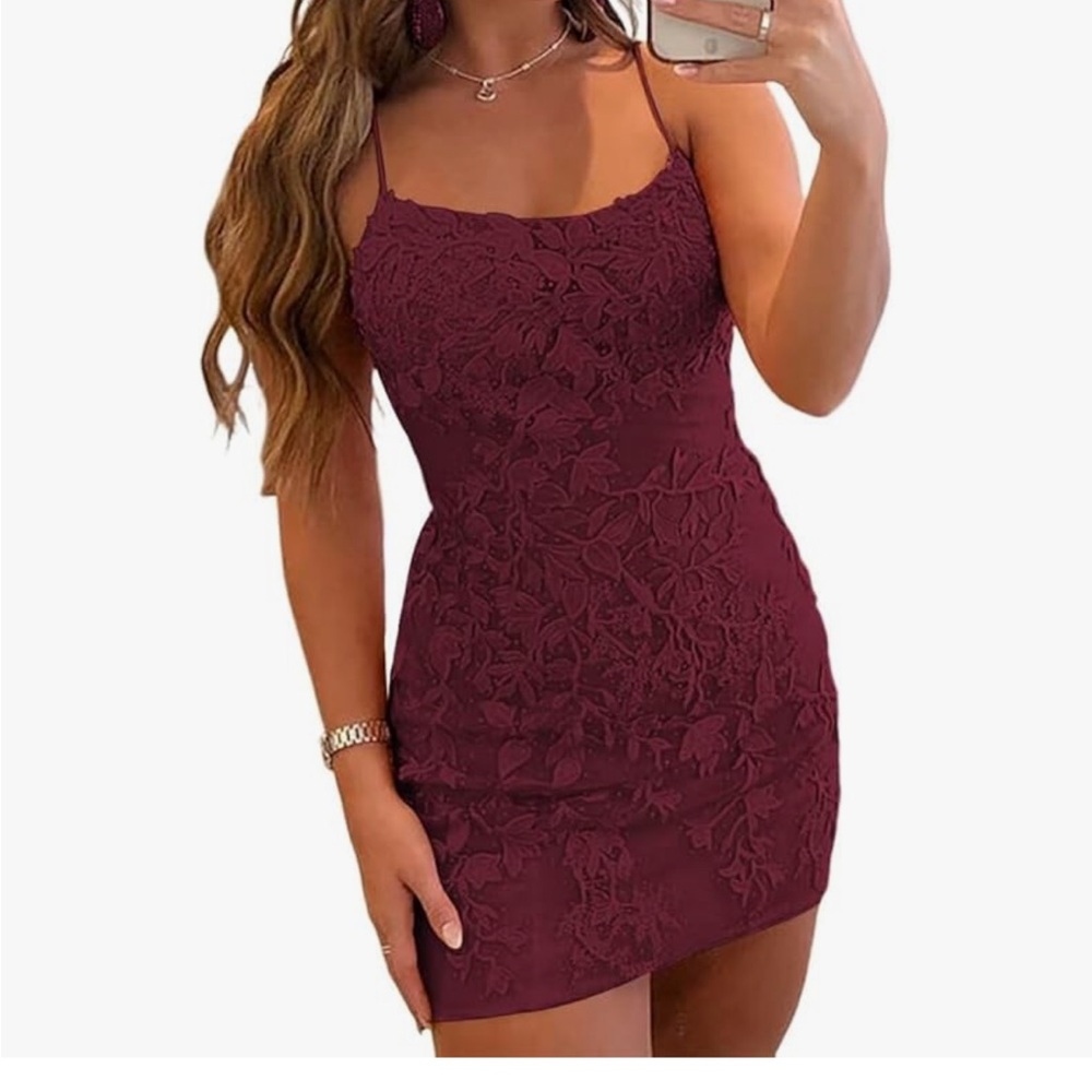 Red lace appliqué dress with spaghetti straps. Lace up back and zipper closure.